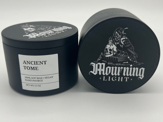 Black candle jar with 'Mourning Light' branding on a white background