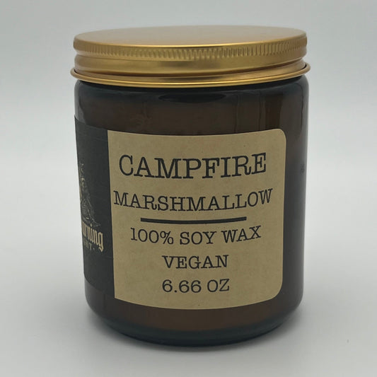 Jar of Campfire Marshmallow candle with a gold lid on a white background