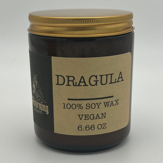 Candle jar with 'Dragula' label on a white background