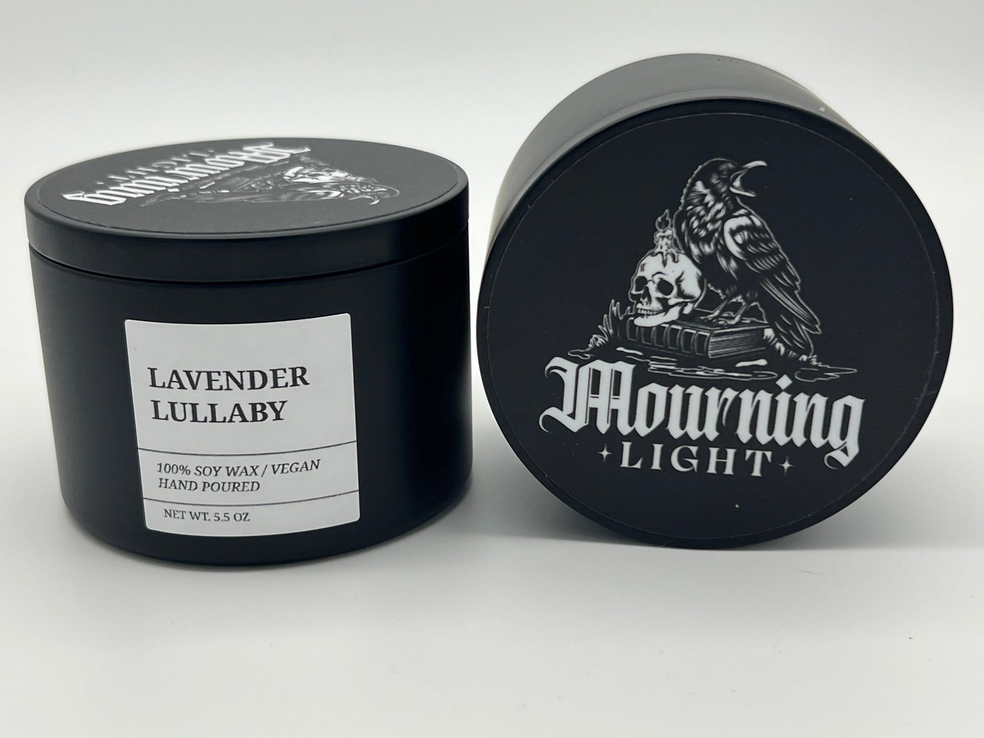 Black candle jar with 'Lavender Lullaby' label and 'Mourning Light' branding on a white background